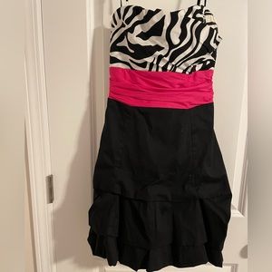 Strappy, Black and white dress with pink bow.